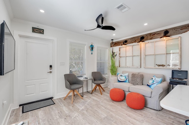 living room with ceiling fan, crown molding, and light hardwood / wood-style flooring