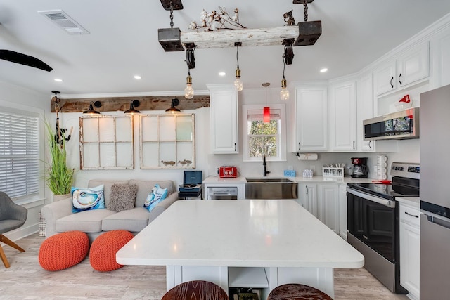 374 San Juan Ave, Santa Rosa Beach, FL 32459 - kitchen with stainless steel appliances, light countertops, white cabinets, recessed lighting, and light wood-style floors