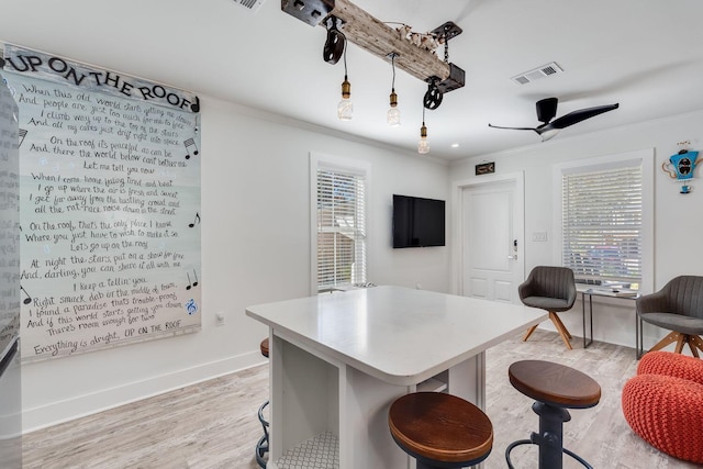 office area featuring light hardwood / wood-style floors, ceiling fan, and ornamental molding