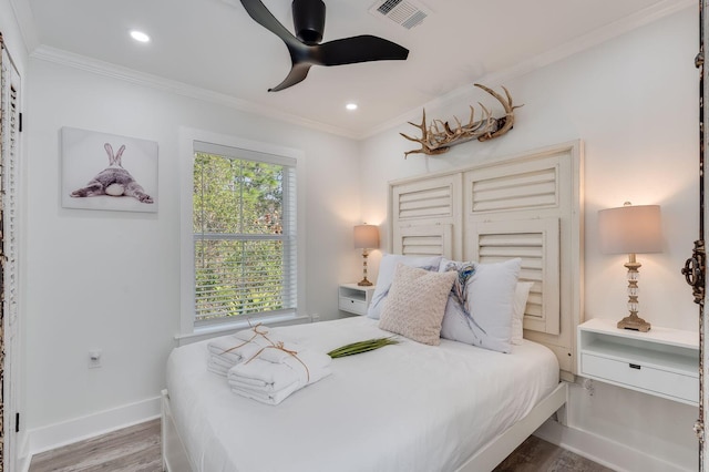 bedroom featuring ceiling fan, wood-type flooring, and crown molding