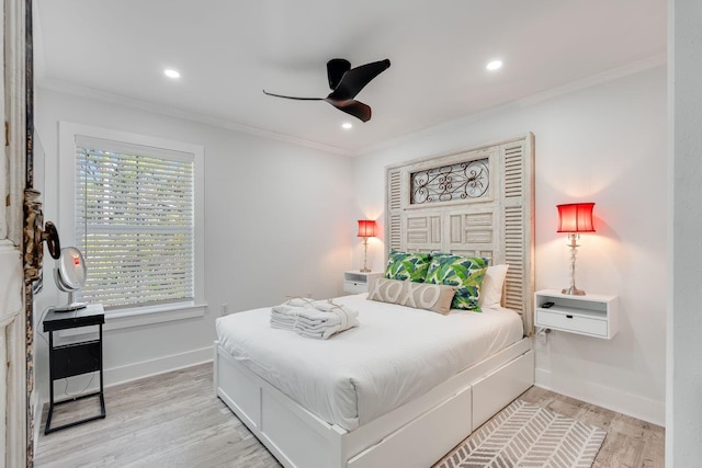 bedroom featuring ceiling fan, light hardwood / wood-style floors, and ornamental molding