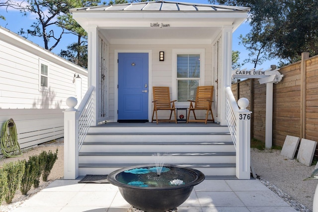 view of exterior entry featuring a porch