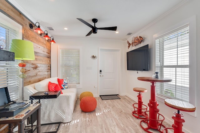 game room with ceiling fan, light hardwood / wood-style flooring, and crown molding