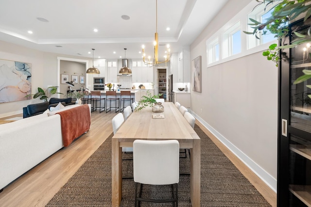 131 W Lafayette Rd, Inlet Beach, FL 32461 - dining area featuring a raised ceiling, light wood-style floors, a chandelier, and recessed lighting