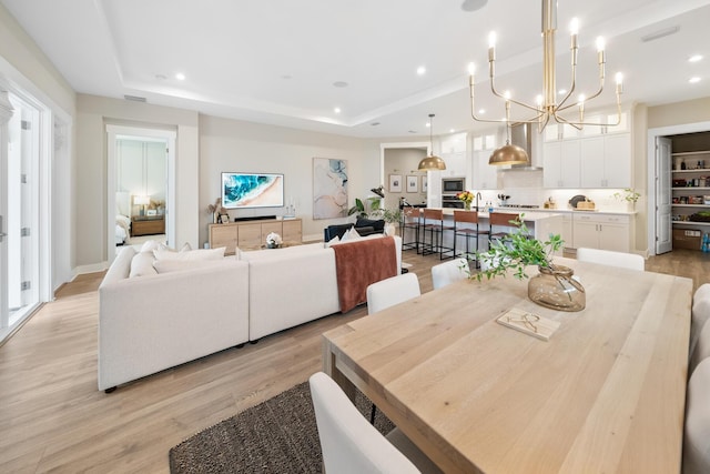 131 W Lafayette Rd, Inlet Beach, FL 32461 - dining area featuring light wood-style floors, a chandelier, a raised ceiling, and recessed lighting