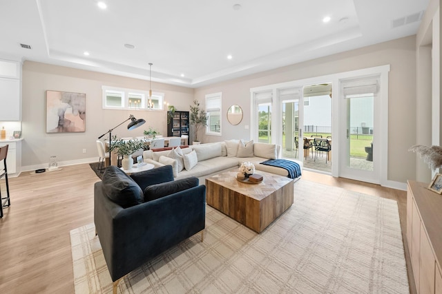 131 W Lafayette Rd, Inlet Beach, FL 32461 - living room with a tray ceiling, light wood finished floors, recessed lighting, and healthy amount of natural light