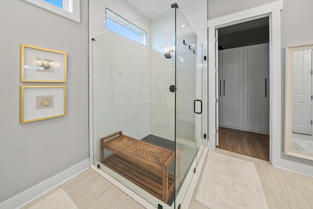 bathroom with tile patterned floors and walk in shower