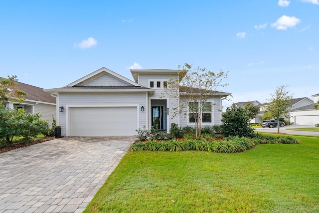 131 W Lafayette Rd, Inlet Beach, FL 32461 - view of front of house featuring a front lawn, decorative driveway, and an attached garage