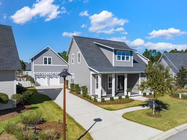 view of front of property with a front lawn, covered porch, and a garage