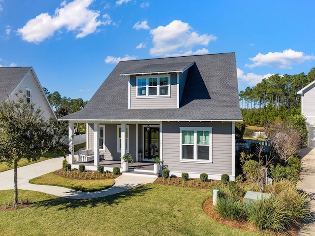 view of front of house featuring covered porch and a front yard