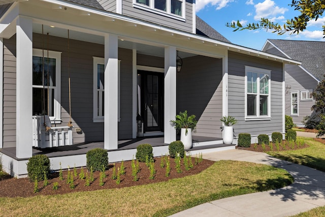 entrance to property featuring a porch