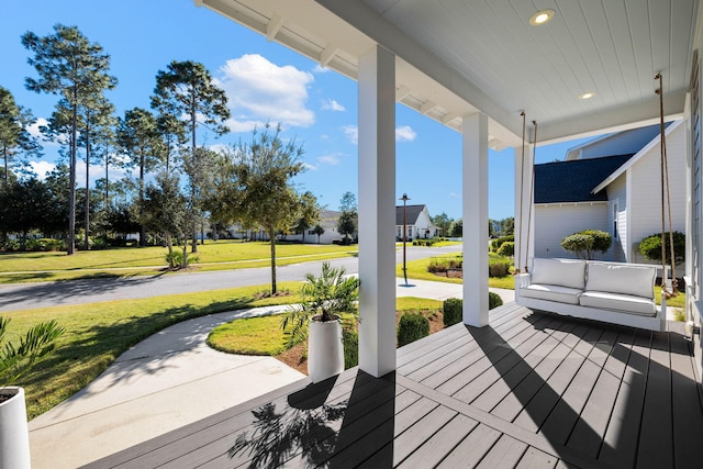 deck with a yard and a porch