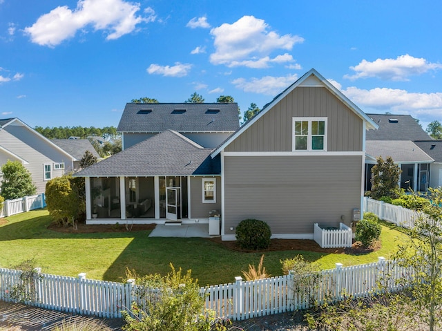 back of property with central air condition unit, a sunroom, a lawn, and a patio