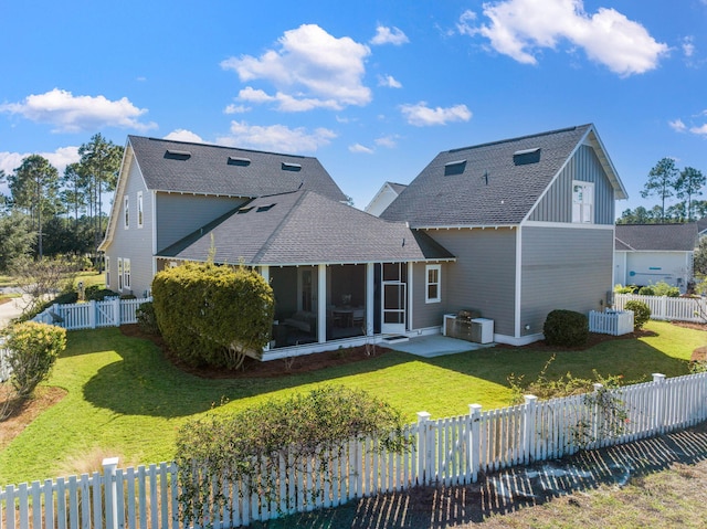 rear view of property with a sunroom and a yard