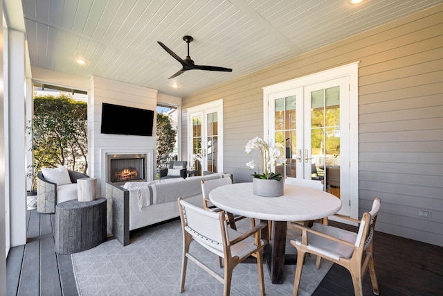 exterior space with ceiling fan, french doors, and exterior fireplace