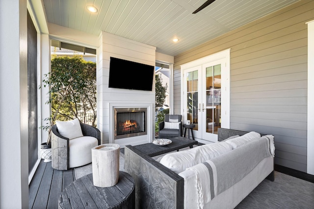 view of patio featuring exterior fireplace and french doors