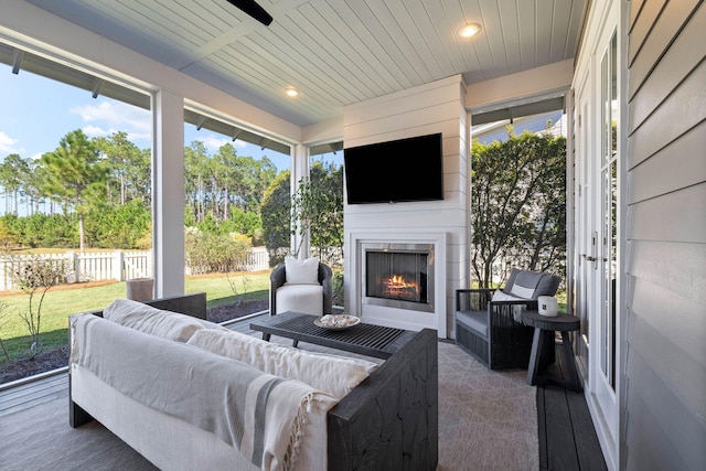 sunroom featuring a fireplace and wooden ceiling