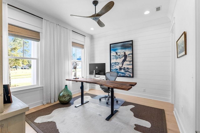 office area featuring ceiling fan, a healthy amount of sunlight, and light hardwood / wood-style flooring