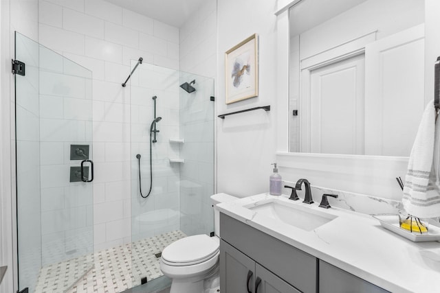 bathroom featuring vanity, toilet, and walk in shower