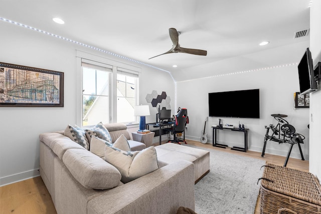 living room featuring hardwood / wood-style flooring and ceiling fan