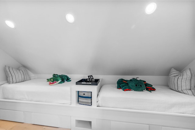 bedroom featuring light hardwood / wood-style floors and vaulted ceiling