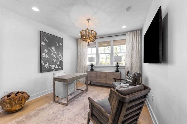 office with a chandelier and light hardwood / wood-style flooring