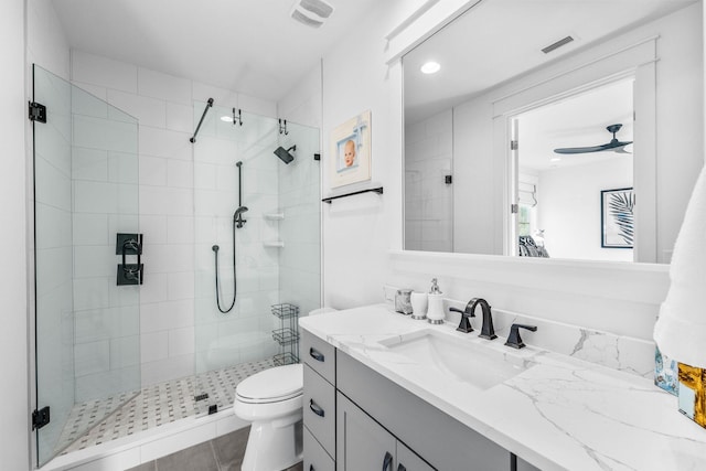 bathroom featuring tile patterned floors, an enclosed shower, vanity, ceiling fan, and toilet