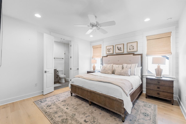 bedroom with ensuite bath, ceiling fan, and light hardwood / wood-style floors