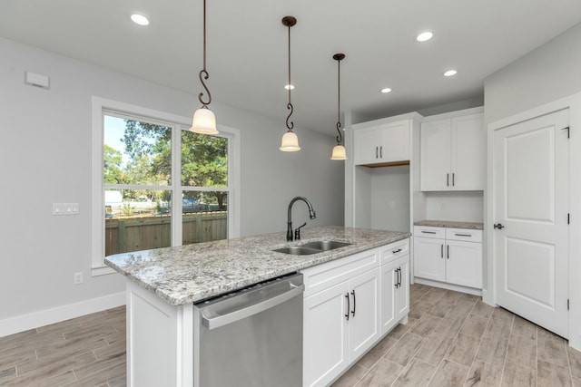 kitchen featuring white cabinetry, dishwasher, an island with sink, and sink