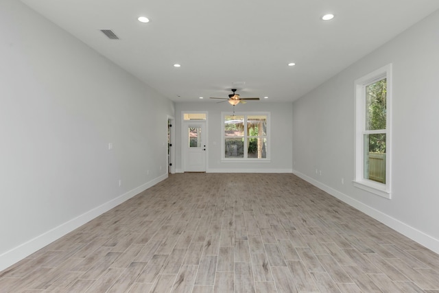 unfurnished living room with light hardwood / wood-style flooring, a wealth of natural light, and ceiling fan