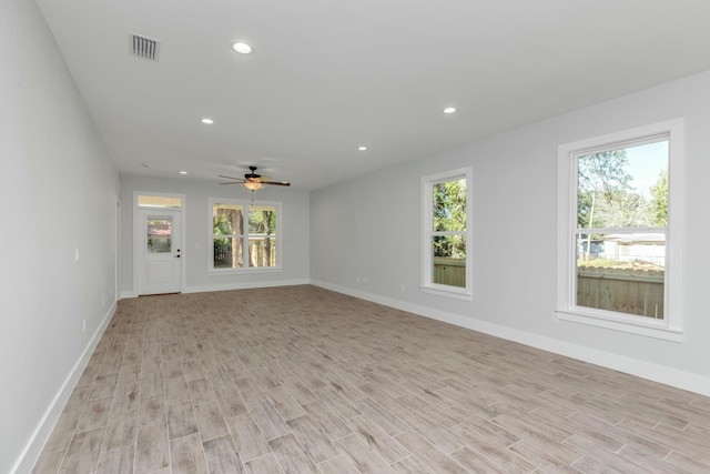 spare room featuring ceiling fan and light hardwood / wood-style flooring