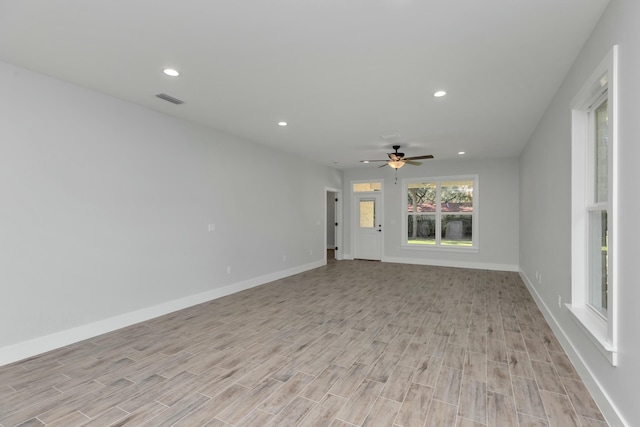 unfurnished living room with ceiling fan and light hardwood / wood-style flooring