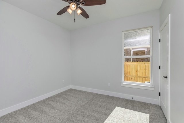 carpeted spare room featuring ceiling fan