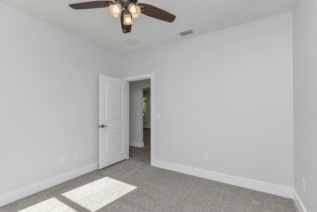 unfurnished room featuring light carpet and ceiling fan