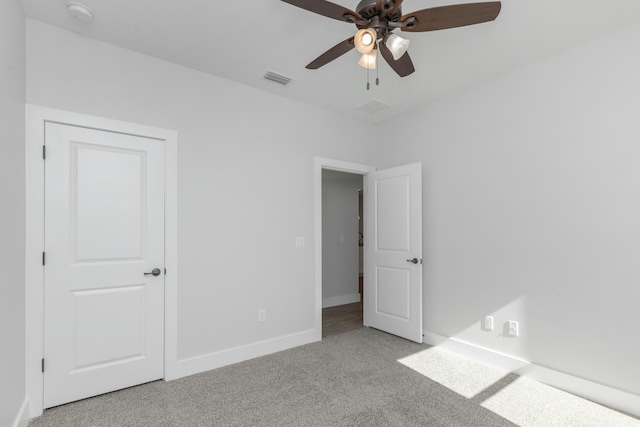 unfurnished bedroom with light carpet and ceiling fan