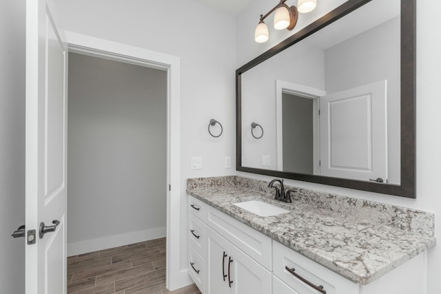 bathroom with hardwood / wood-style floors and vanity