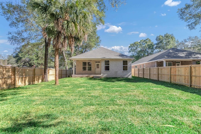 back of house with a yard