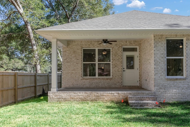 doorway to property with a yard, ceiling fan, and a patio area