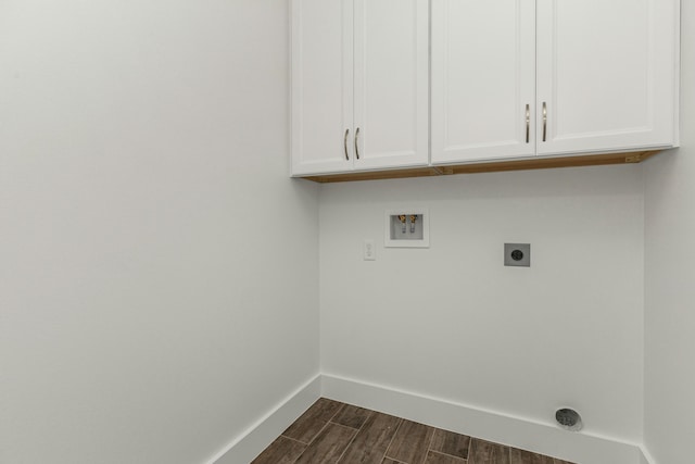 laundry room with hookup for a washing machine, cabinets, dark hardwood / wood-style floors, and hookup for an electric dryer