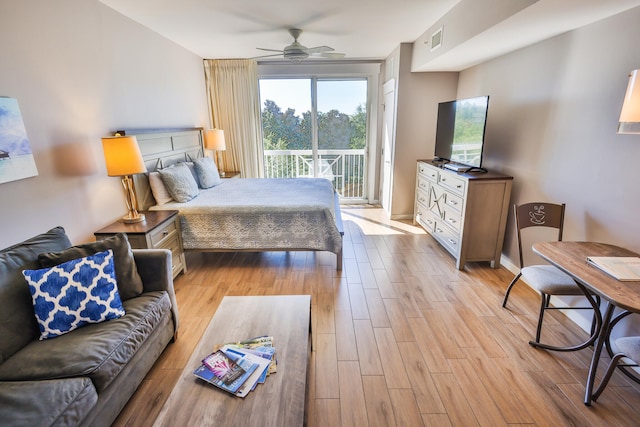 bedroom featuring access to exterior, ceiling fan, and light hardwood / wood-style flooring