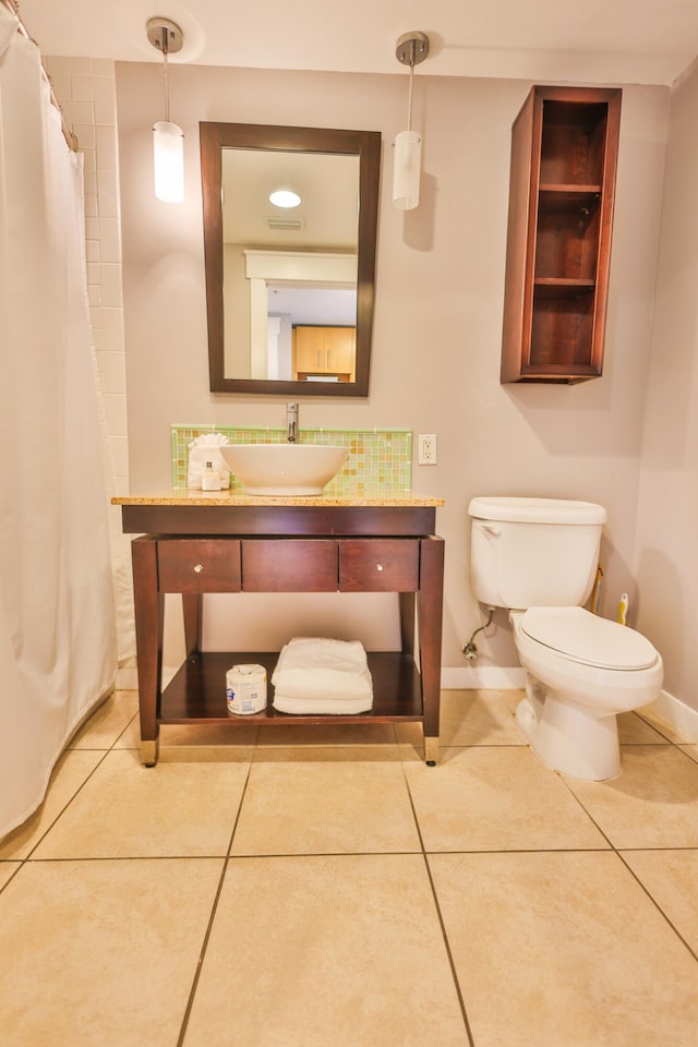 bathroom featuring tile patterned flooring, vanity, and toilet