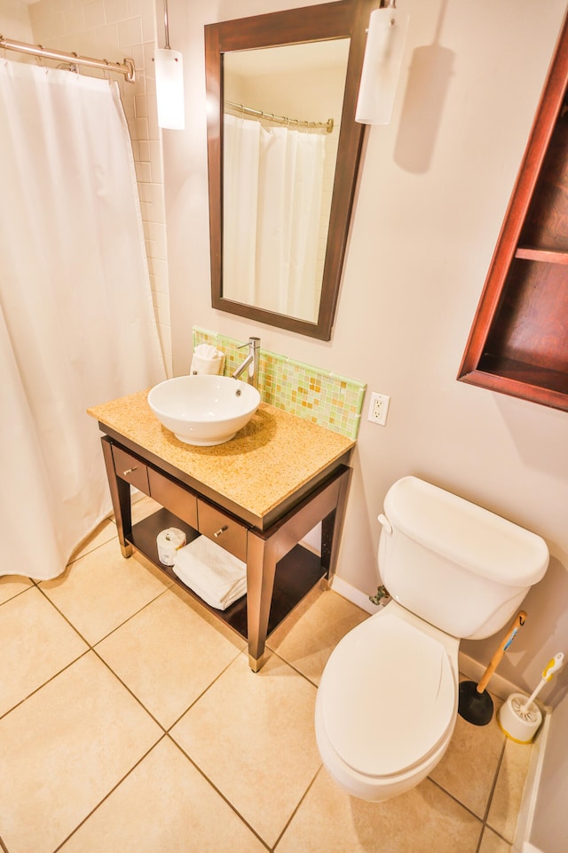 bathroom with tile patterned flooring, a shower with curtain, vanity, and toilet