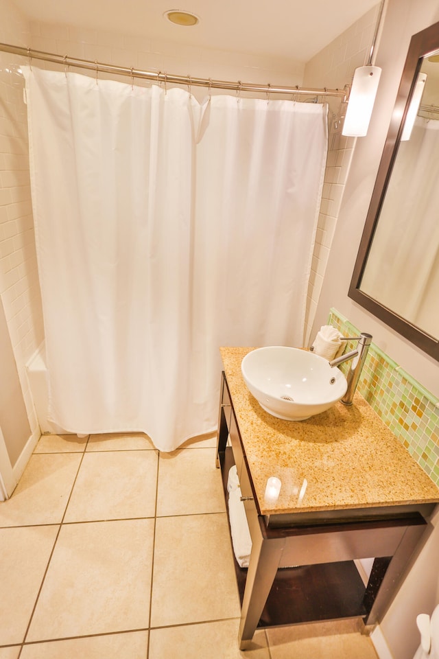 bathroom featuring tile patterned flooring, vanity, and shower / bath combo