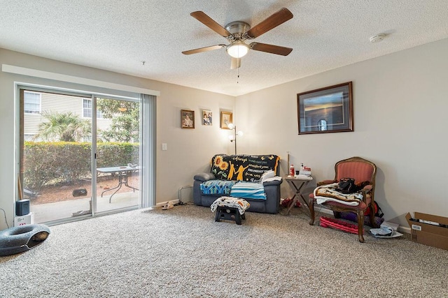 living area featuring carpet floors and a textured ceiling