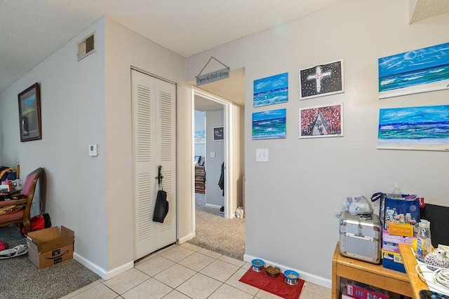 hall featuring light tile patterned floors