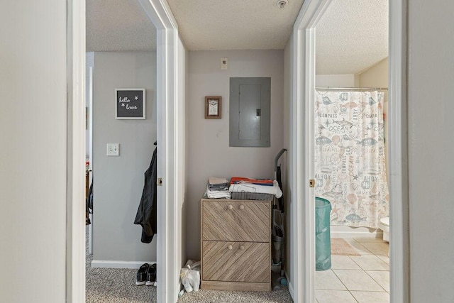 bathroom featuring tile patterned floors, toilet, a textured ceiling, and electric panel