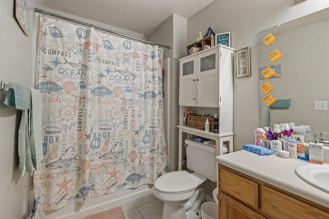 full bathroom with tile patterned flooring, a textured ceiling, toilet, vanity, and shower / tub combo