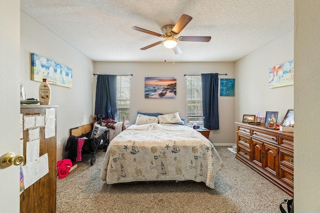 carpeted bedroom featuring a textured ceiling and ceiling fan