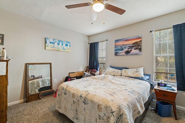 carpeted bedroom with multiple windows, a textured ceiling, and ceiling fan