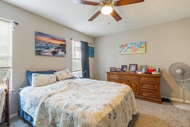 bedroom with ceiling fan, light colored carpet, and multiple windows